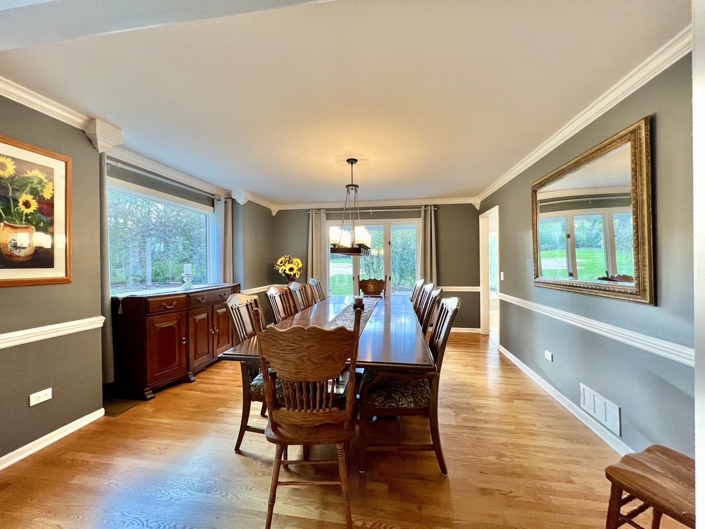4111 Steeple Run Crystal Lake, IL 60014 - Photo 7 of 50 a view of a dining room with furniture a chandelier and wooden floor