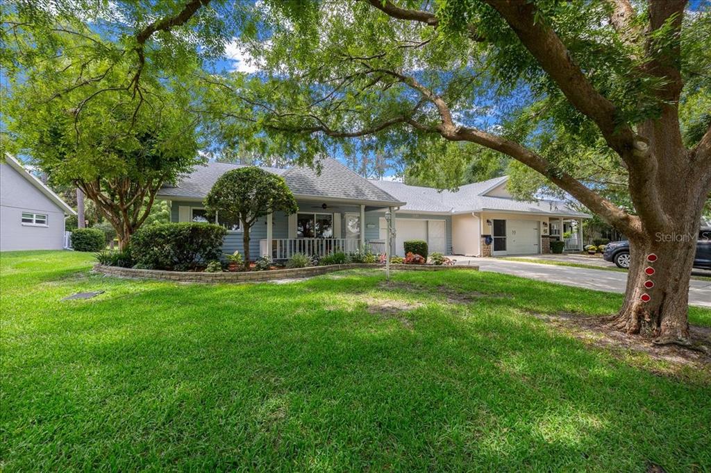 8720 Southwest 90th Street, Unit A Ocala, FL 34481 - Photo 9 of 71 a front view of a house with a garden and porch