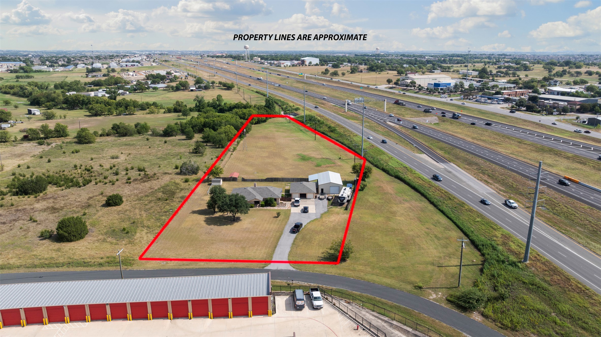 1512 Panther Loop Pflugerville, TX 78660 - Photo 37 of 40 An aerial perspective reveals a vast estate with highway frontage and verdant land.