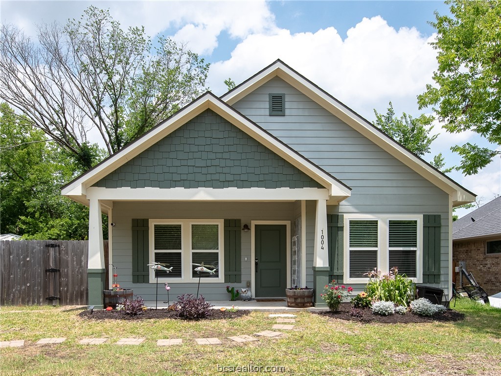 a front view of house with yard outdoor seating and pathway