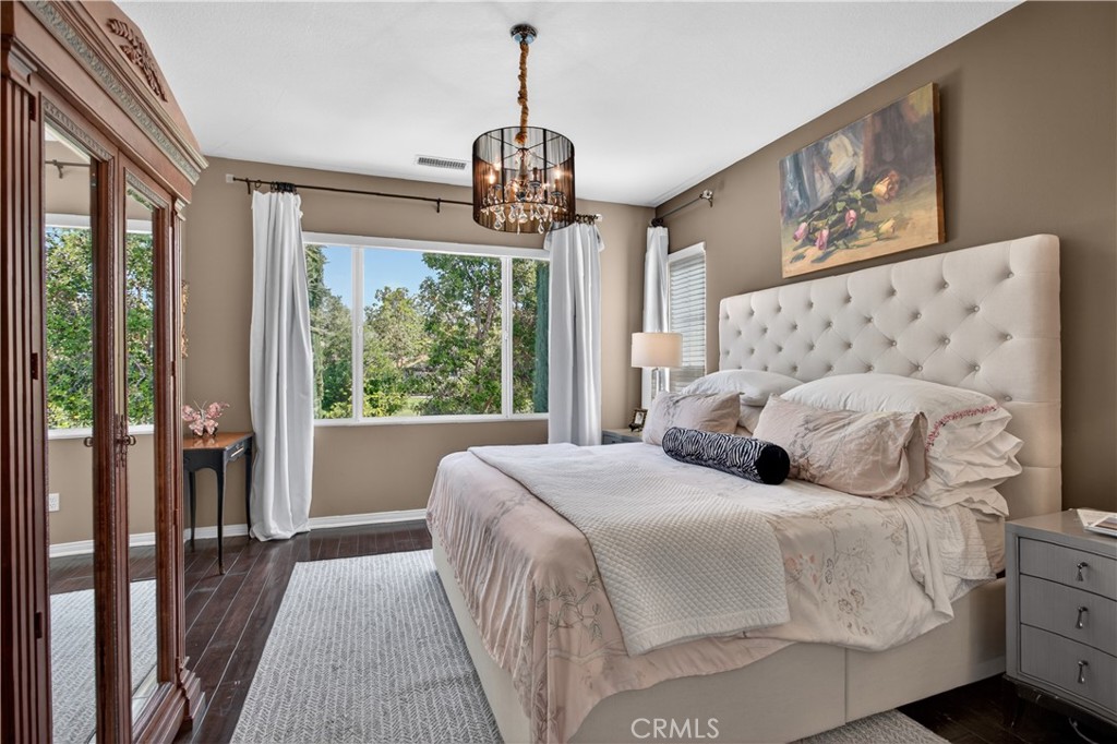 89 Dawnwood Ladera Ranch, CA 92694 - Photo 23 of 47 a bedroom with a large bed and a chandelier