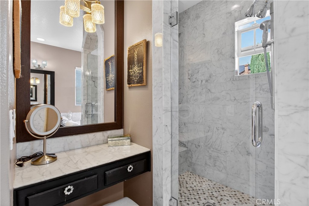 89 Dawnwood Ladera Ranch, CA 92694 - Photo 27 of 47 a bathroom with a granite countertop sink a mirror and shower