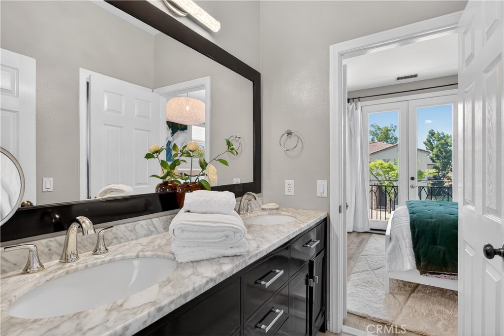 89 Dawnwood Ladera Ranch, CA 92694 - Photo 28 of 47 a bathroom with a granite countertop sink a toilet and a mirror