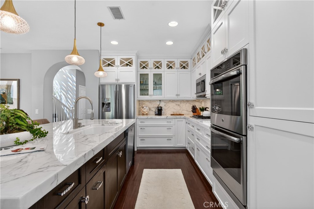 89 Dawnwood Ladera Ranch, CA 92694 - Photo 3 of 47 a large kitchen with stainless steel appliances kitchen island granite countertop a stove a sink and a refrigerator