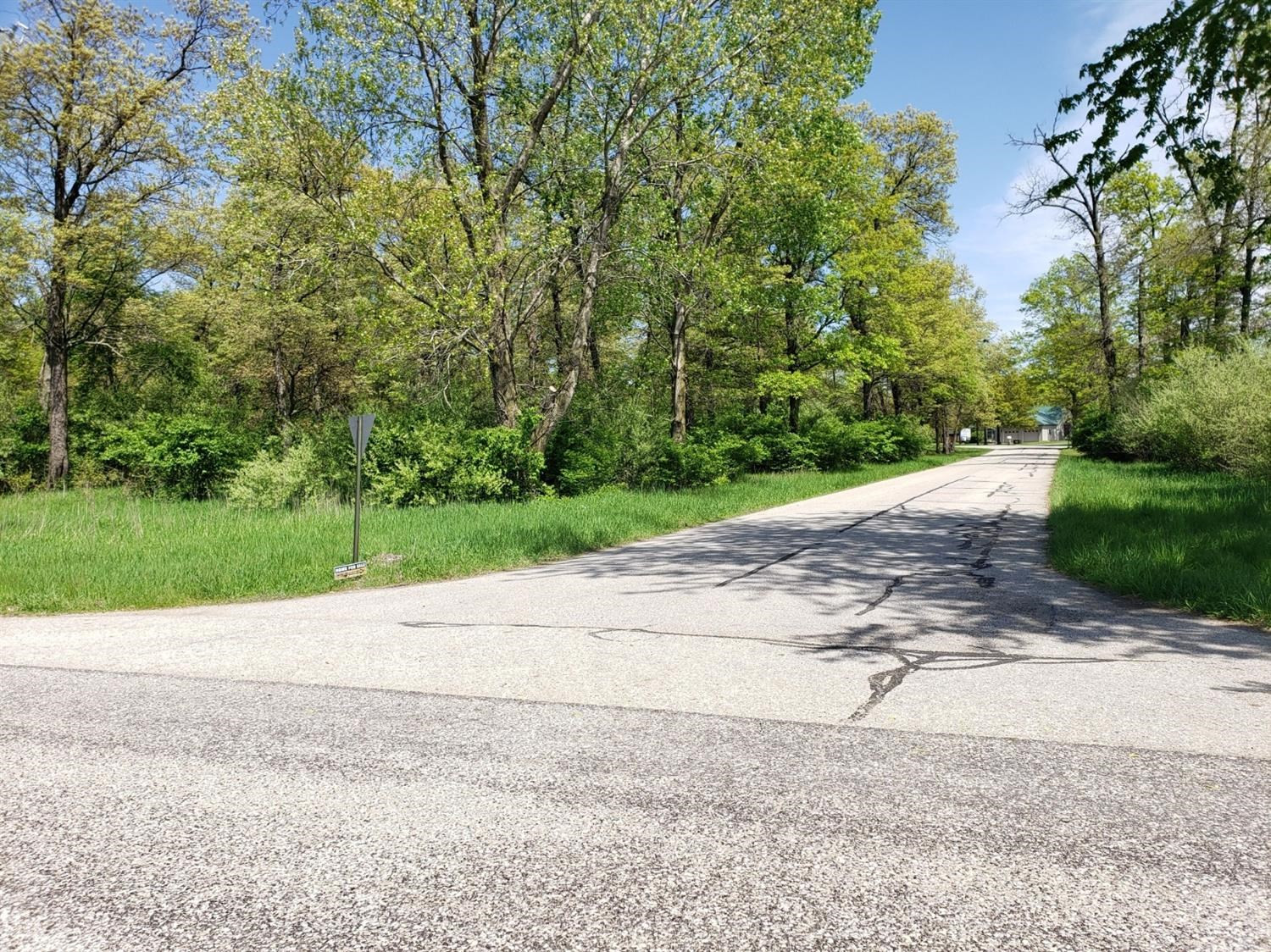 10 272nd Street South Morocco, IN 47963 - Photo 1 of 5 a view of a road with a yard and large trees