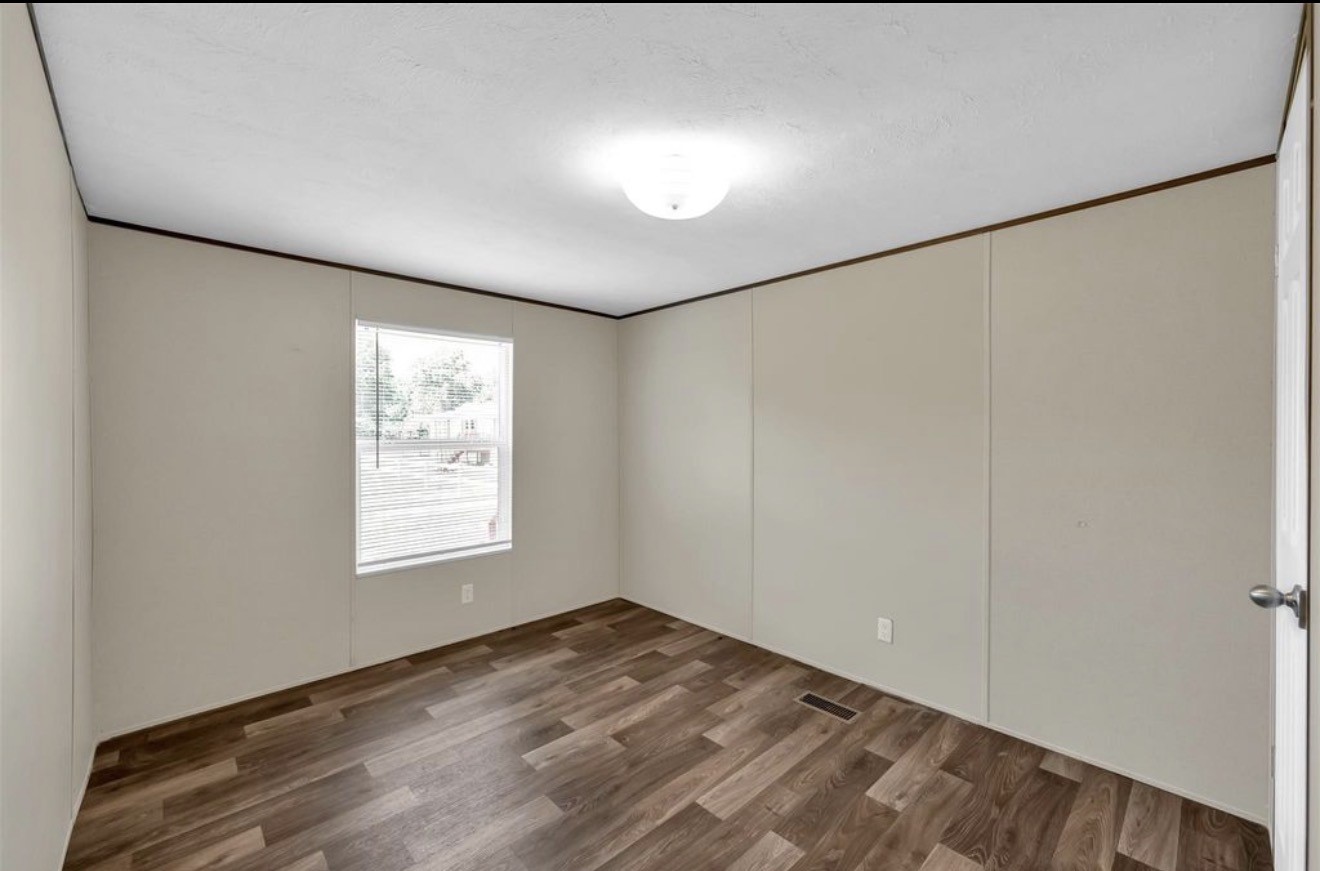 26768 B Dobbin-Huffsmith Road Magnolia, TX 77354 - Photo 15 of 21 an empty room with wooden floor and windows