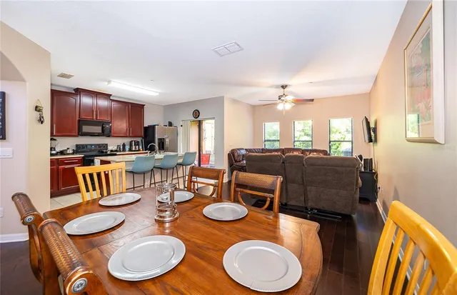 a living room with furniture ceiling fan