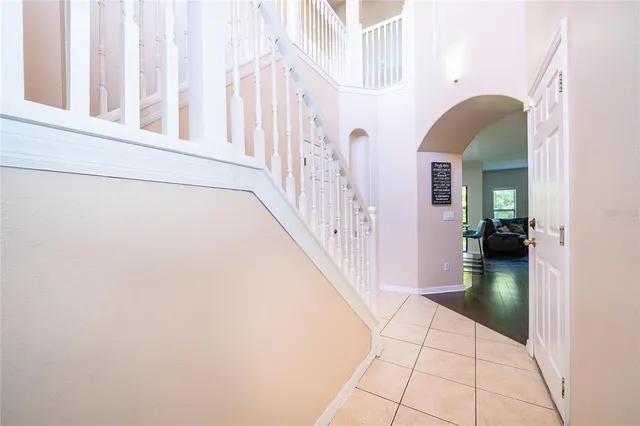a view of a hallway with dining room and stairs