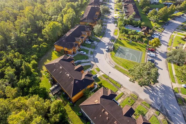 an aerial view of a house with a yard and swimming pool