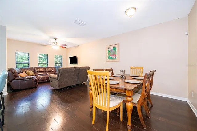 a view of a dining room with furniture and wooden floor