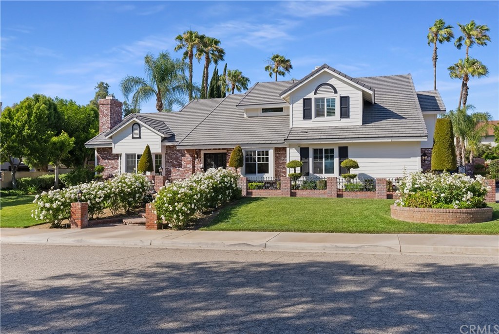 a front view of a house with a garden and plants