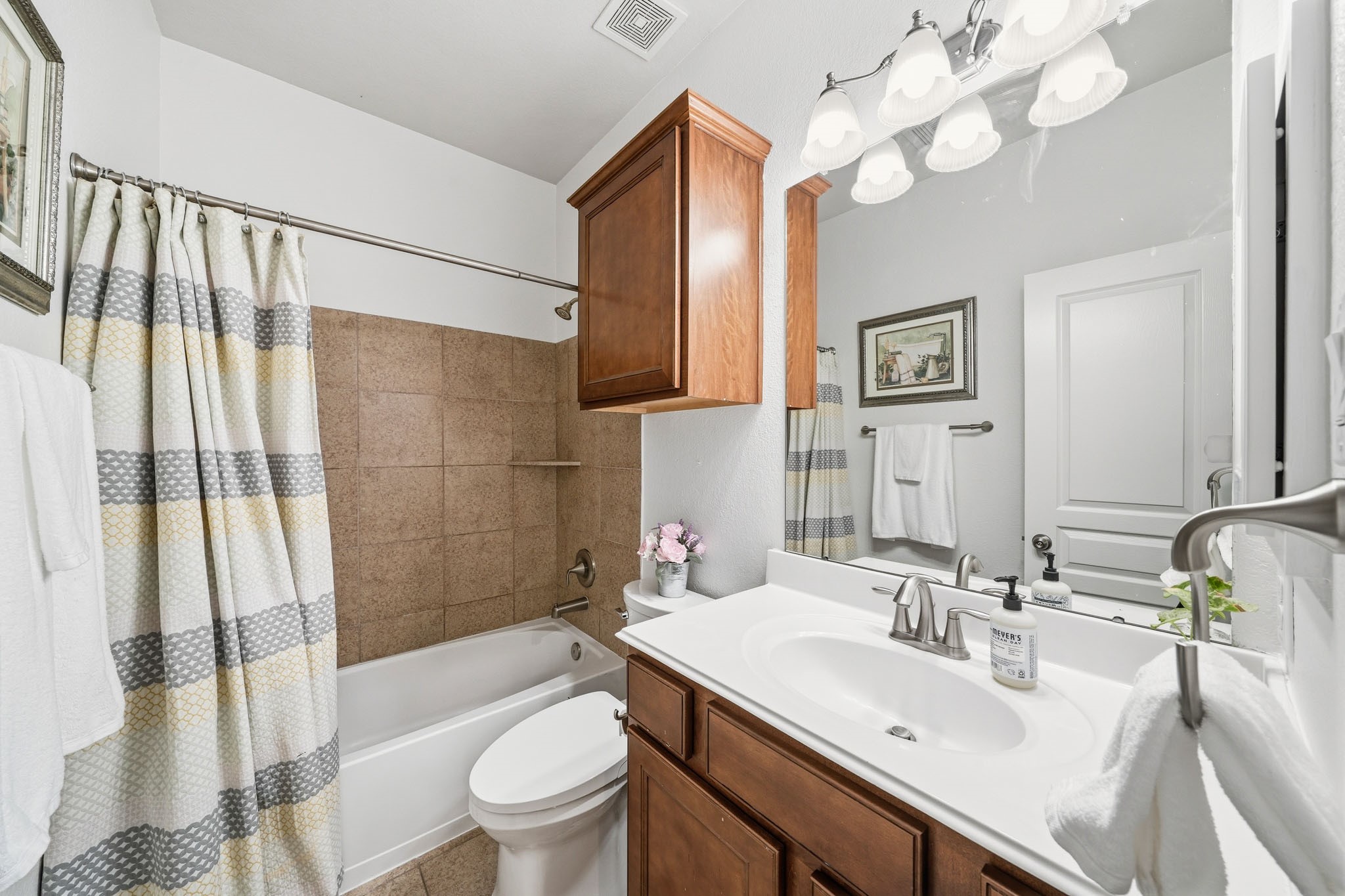 17610 Strackfield Lane Tomball, TX 77377 - Photo 32 of 50 A serene and self-contained retreat, the ensuite bath enhances everyday convenience, while tile floors, a cultured marble sink and a tiled tub-shower surround create a timeless, low-maintenance space.