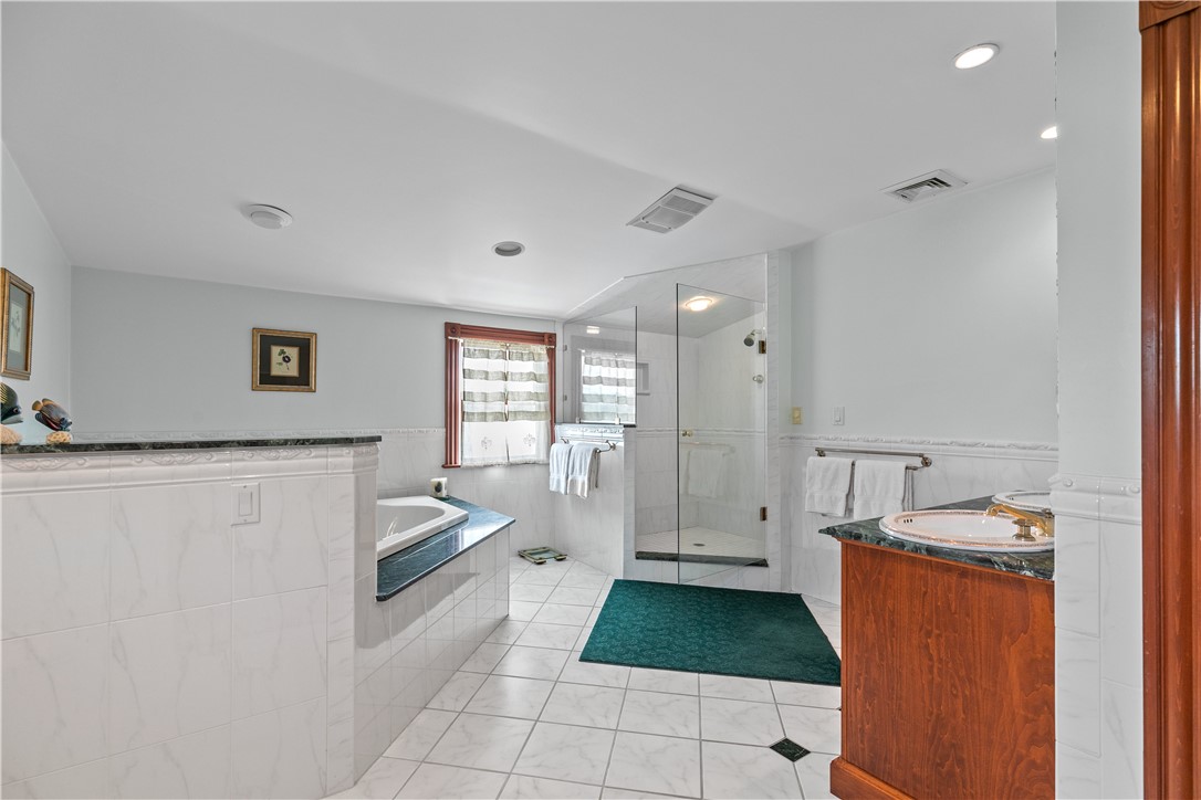 23 Clinton Street Newport, RI 02840 - Photo 29 of 45 Large galss doored and tiled shower with jacuzzi jet tub.