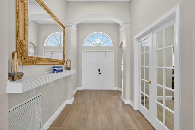 a view of a kitchen with wooden floor and a large window