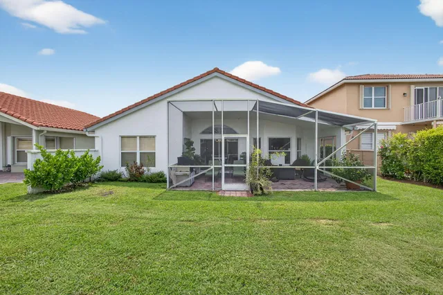 a view of a house with a yard and sitting area