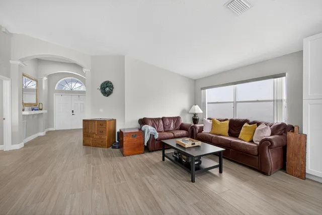 a living room with furniture a rug and a window