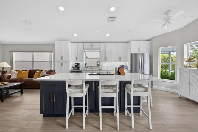 a open dining room with stainless steel appliances granite countertop a table and chairs