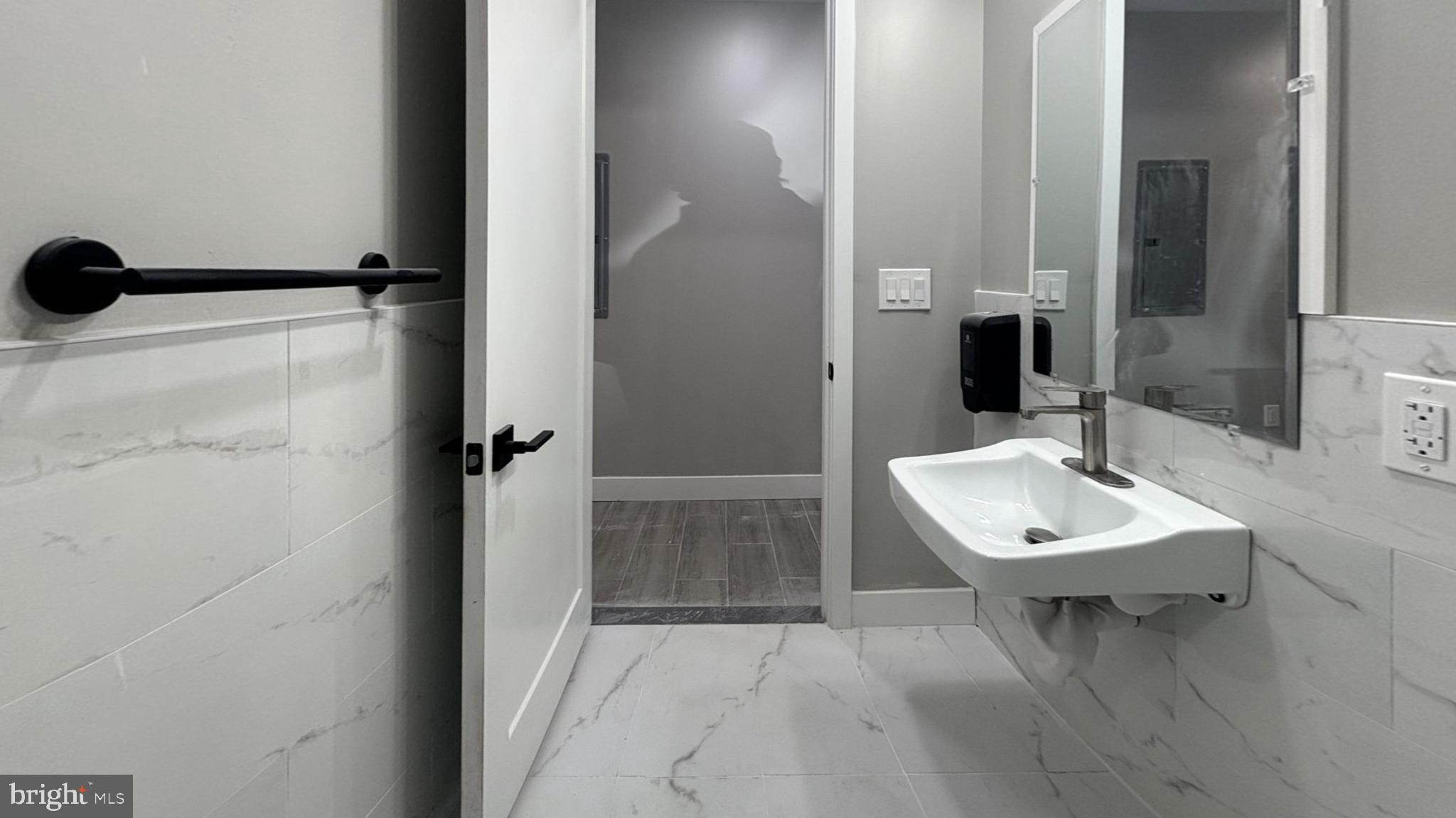 5341 Chestnut Street, Unit 1 Philadelphia, PA 19139 - Photo 2 of 4 a bathroom with a sink and a mirror