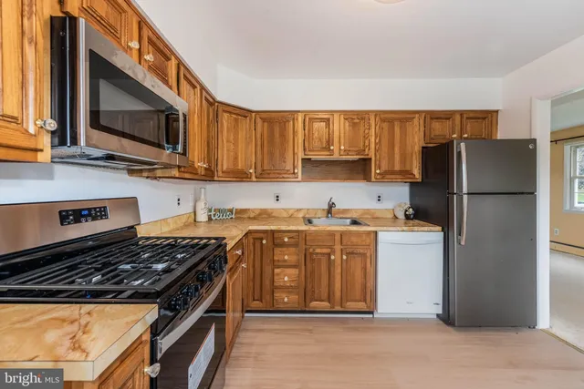 a kitchen with a refrigerator stove and microwave