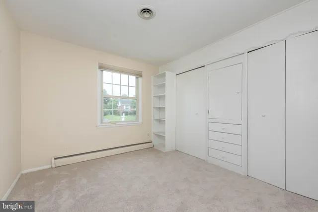 an empty room with closet area