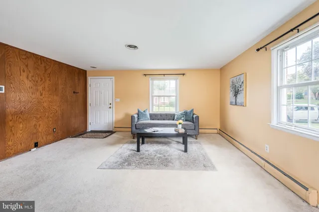 a living room with furniture a window and a table