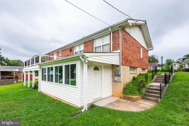 a front view of a house with a yard table and chairs