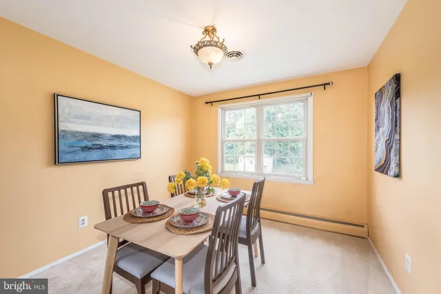 a dining room with furniture and window