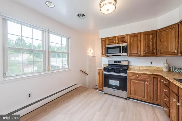 a kitchen with a stove a sink and a microwave