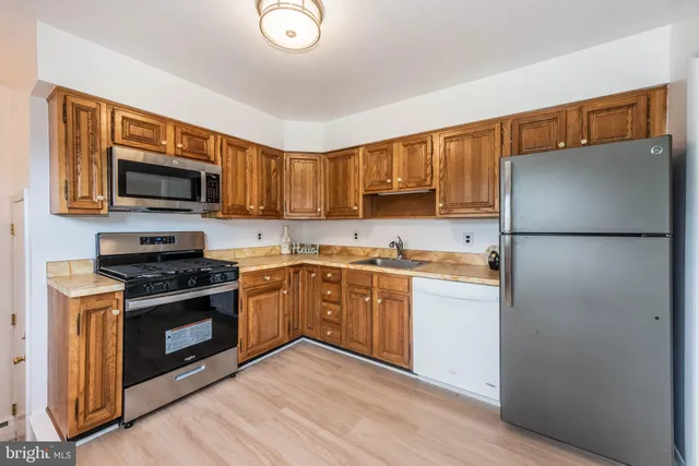 a kitchen with a refrigerator stove and microwave