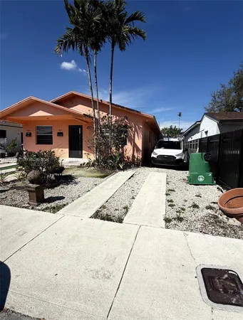 a view of a house with a yard and sitting area