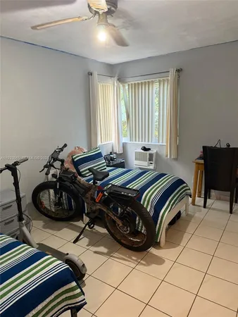 a bedroom with a bed and a chair