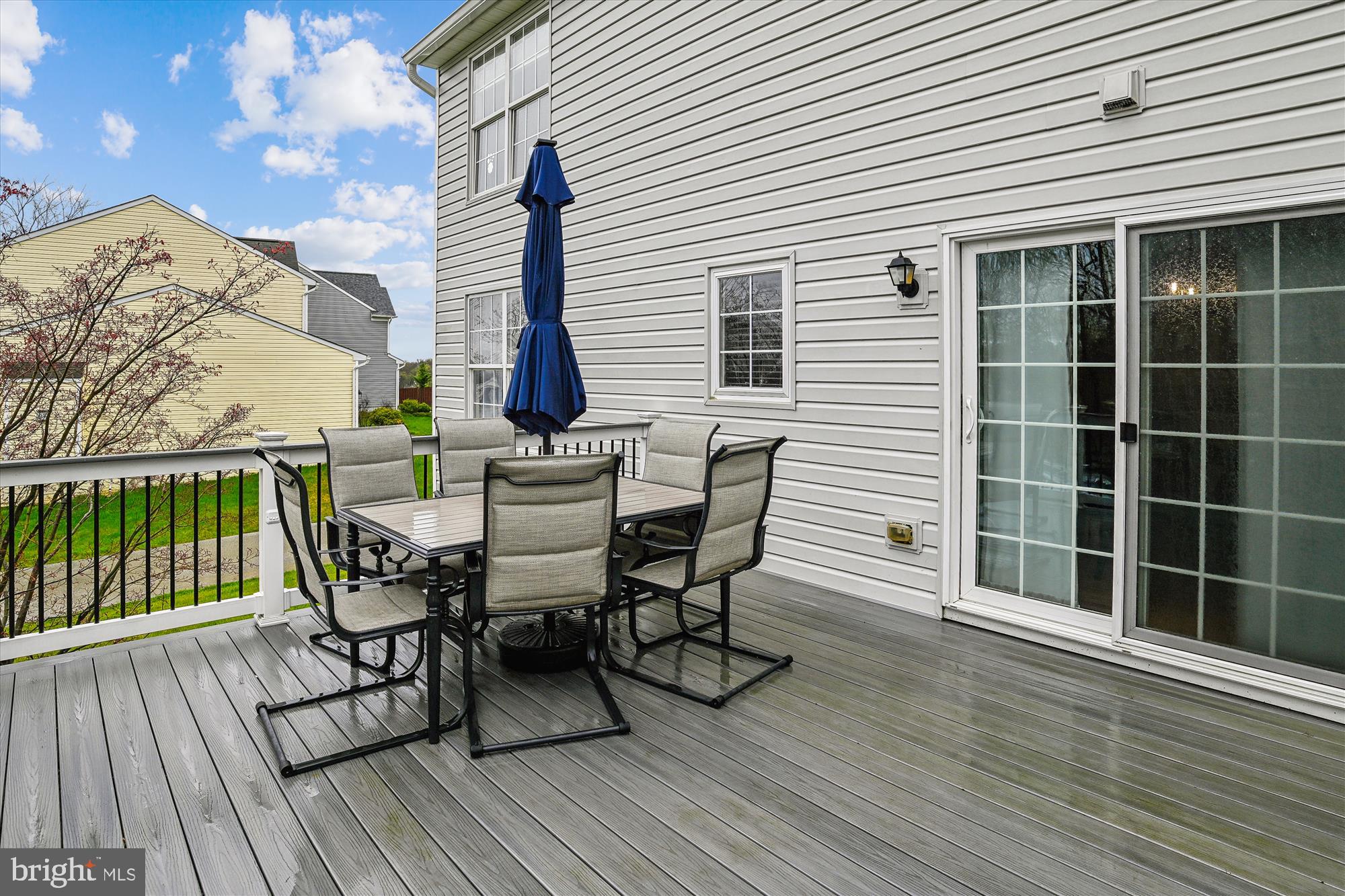 5958 Florey Road Hanover, MD 21076 - Photo 14 of 77 a view of a roof deck with table and chairs with wooden floor and fence