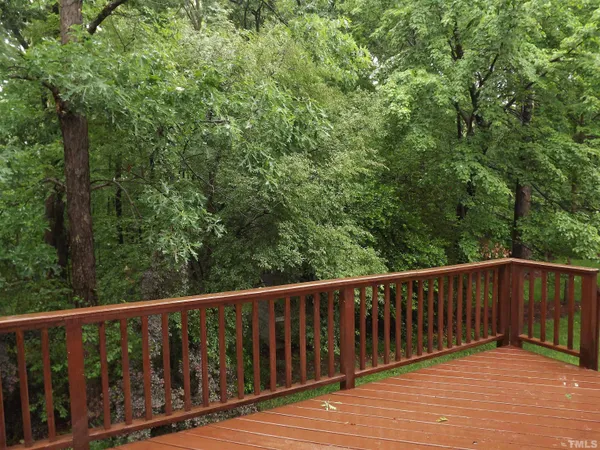 a balcony with wooden floor and fence
