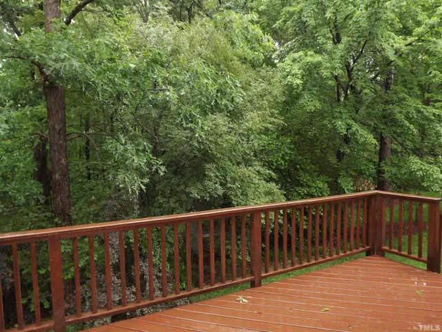 a balcony with wooden floor and fence