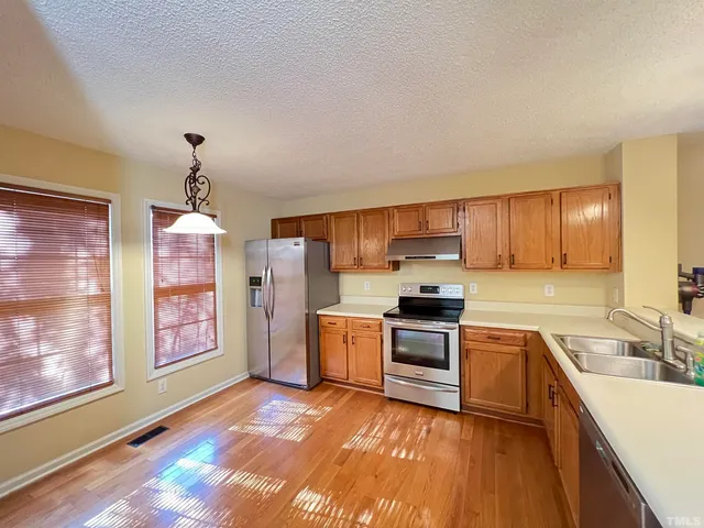 a kitchen with a sink stove and refrigerator