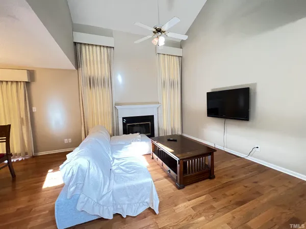 a living room with furniture flat screen tv and a fireplace