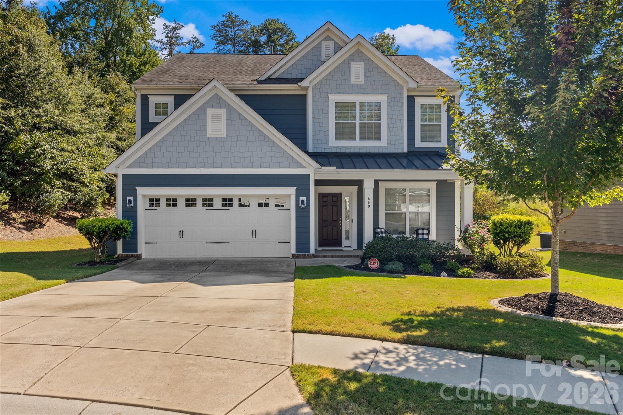 a view of house with yard in front of it