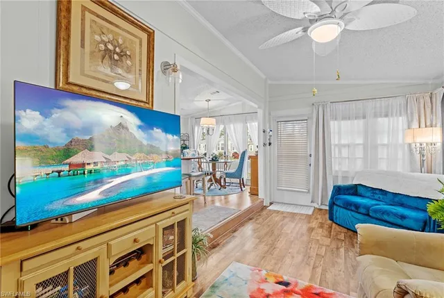 a view of a room with furniture and wooden floor