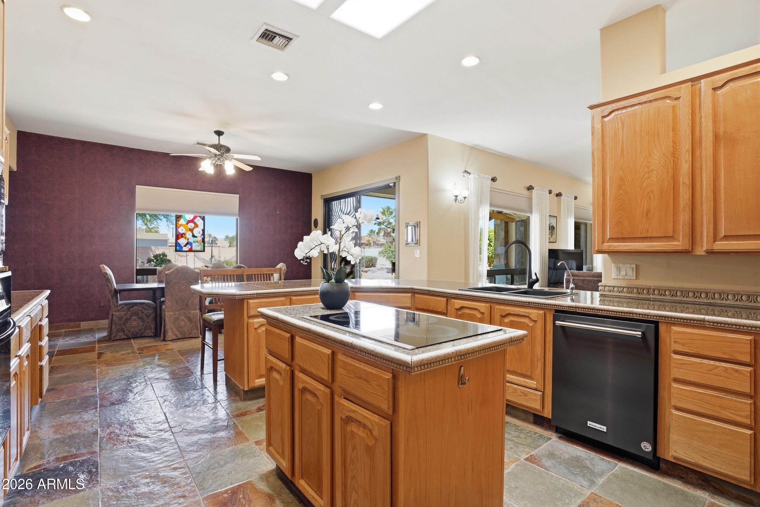 6334 East Albany Street Mesa, AZ 85205 - Photo 22 of 72 a kitchen with stainless steel appliances granite countertop sink stove and table