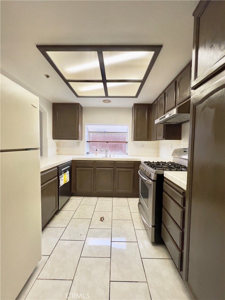 12143 Ferris Road El Monte, CA 91732 - Photo 11 of 41 a kitchen with stainless steel appliances granite countertop a sink stove and refrigerator
