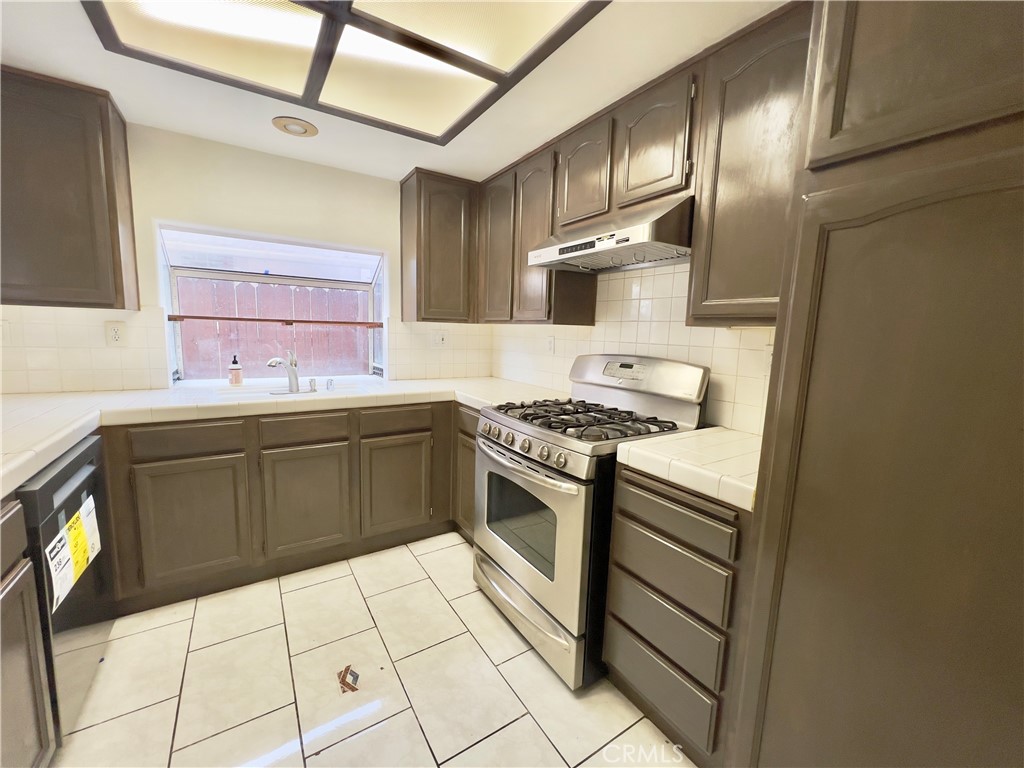 12143 Ferris Road El Monte, CA 91732 - Photo 12 of 41 a kitchen with stainless steel appliances granite countertop a sink stove and cabinets