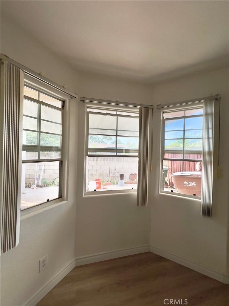 12143 Ferris Road El Monte, CA 91732 - Photo 17 of 41 a view of an empty room with wooden floor and a window