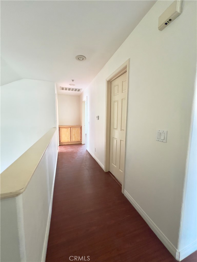 12143 Ferris Road El Monte, CA 91732 - Photo 23 of 41 a view of hallway with stairs and wooden floor