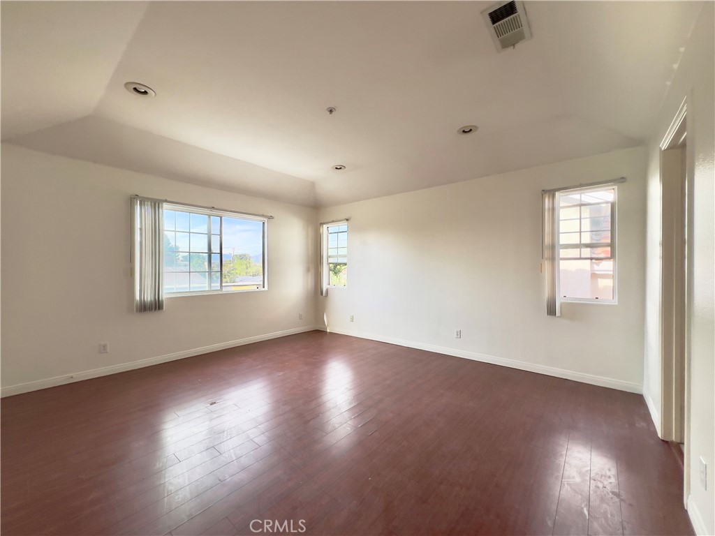 12143 Ferris Road El Monte, CA 91732 - Photo 24 of 41 an empty room with wooden floor and windows