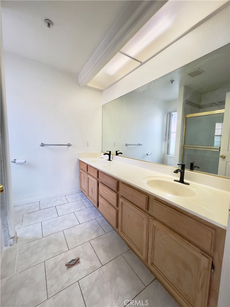 12143 Ferris Road El Monte, CA 91732 - Photo 28 of 41 a spacious bathroom with a double vanity sink a mirror and a