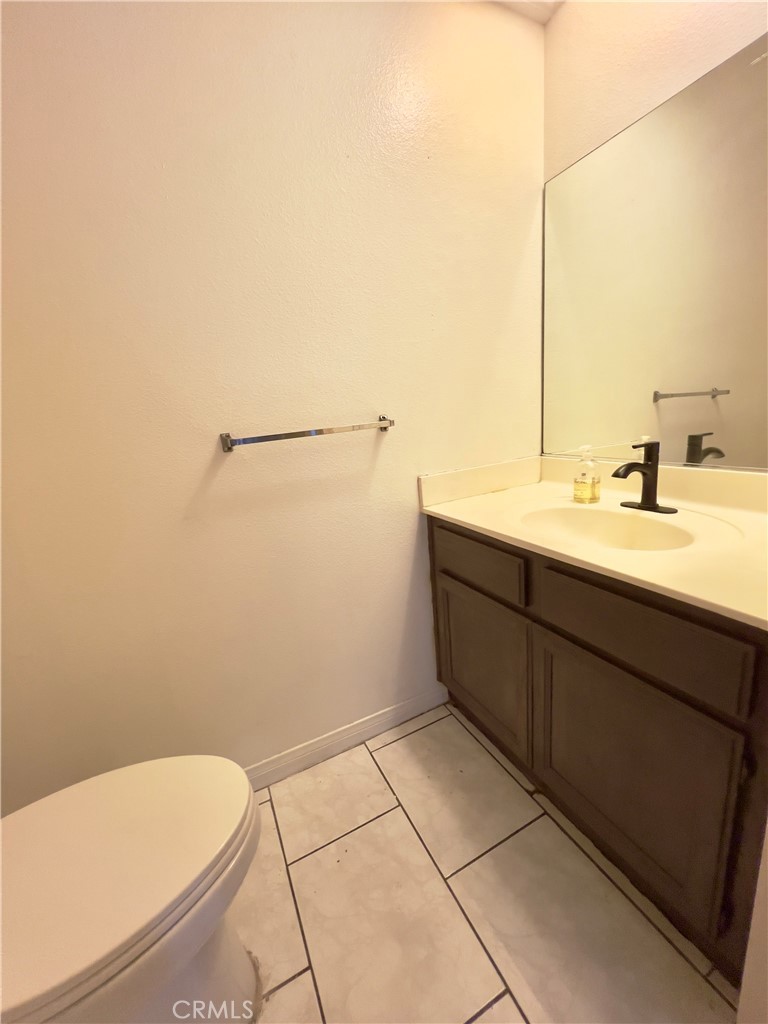 12143 Ferris Road El Monte, CA 91732 - Photo 32 of 41 a bathroom with a granite countertop sink and a toilet