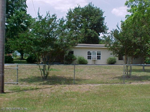 2410 Chuck Road Jacksonville, FL 32221 - Photo 1 of 4 a view of a house with a backyard and a tree