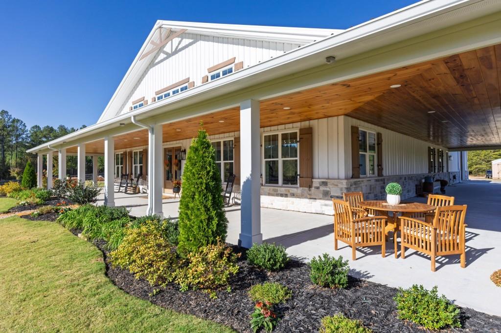 125 Perry Road Rydal, GA 30171 - Photo 102 of 139 a view of a house with backyard sitting area and porch
