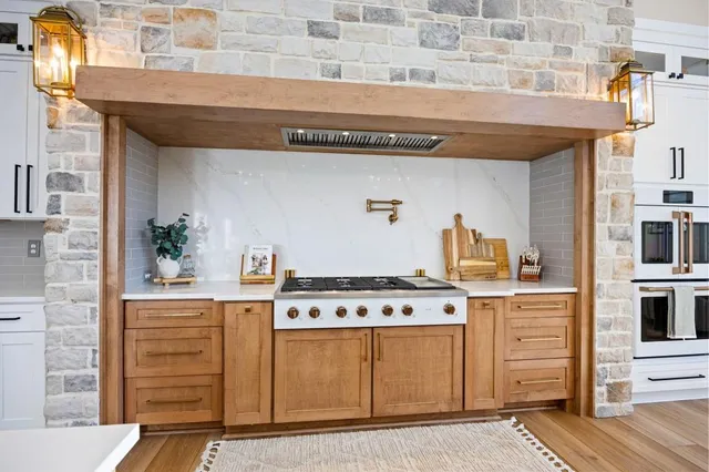 a view of a dining room with furniture a fireplace and wooden floor