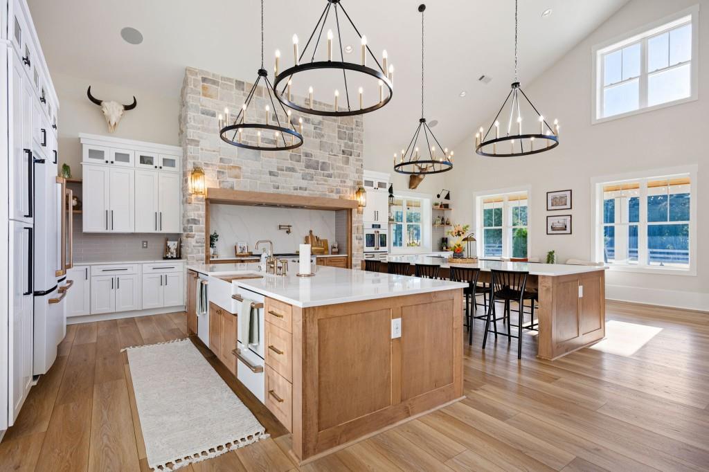 125 Perry Road Rydal, GA 30171 - Photo 15 of 139 a kitchen with stainless steel appliances granite countertop a stove a sink dishwasher and white cabinets with wooden floor